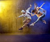 Stylish dancers fancing in a concrete area Fototapety do Szkoły Tańca Fototapeta