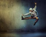 Athletic dancer in a jumping pose Fototapety do Szkoły Tańca Fototapeta
