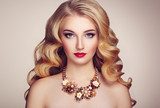 Fashion portrait of young beautiful woman with jewelry and elegant hairstyle. Blonde girl with long wavy hair. Perfect make-up.  Beauty style model Obrazy do Salonu Fryzjerskiego Obraz