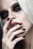 Beautiful blond girl with dark smokey makeup and art manicure design nails. beauty face. Photos shot in studio Obrazy do Salonu Kosmetycznego Obraz
