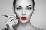 Black and white photo of woman painting lipstick. Beautiful woman face. Makeup detail. Beauty girl with perfect skin. Red lips and nails manicure Obrazy do Salonu Kosmetycznego Obraz