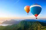 Colorful hot-air balloons flying over the mountain  Pejzaże Plakat