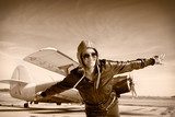 Happy young woman with raised hands  flying on airporte,  Fototapety Sepia Fototapeta