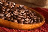 Roasted coffee beans on wooden plate on red cloth  Kawa Fototapeta