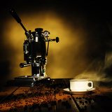 Cup of coffee and coffee machine on the table  Kawa Fototapeta