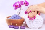 female hands with fragrant orchid and towel. Spa  Obrazy do Salonu SPA Obraz