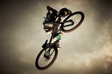 Young man flying on his bike: Dirt jump  Sport Fototapeta