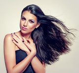 Beautiful brunette with long hair flying  Obrazy do Salonu Kosmetycznego Obraz