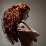 Beautiful woman with curly hairstyle against gray background  Obrazy do Salonu Kosmetycznego Obraz