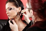 Brunette having applied face tattoo by makeup artist  Obrazy do Salonu Kosmetycznego Obraz