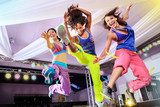 young women in sport dress jumping at an aerobic and zumba exerc  Fototapety do Szkoły Tańca Fototapeta