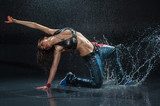 Wet dancing woman. Under waterdrops. Studio photo  Fototapety do Szkoły Tańca Fototapeta