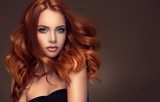 Beautiful model girl with long red curly hair .Red head . Care products ,hair colouring . Fototapety do Salonu Fryzjerskiego Fototapeta