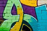 Graffity: Colorful detail on a textured brick wall Fototapety Graffiti Fototapeta