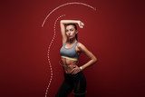 Power and beauty. Sportswoman standing over red background, looking away. Graphic drawing. Fototapety do Klubu Fitness Fototapeta