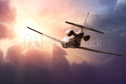 Private Jet PLane in the sky at sunset  Pojazdy Fototapeta