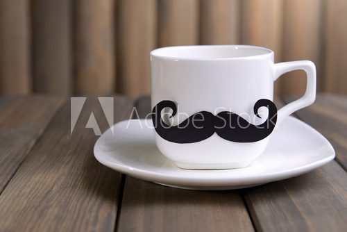Cup with mustache on table on wooden background  Kawa Fototapeta