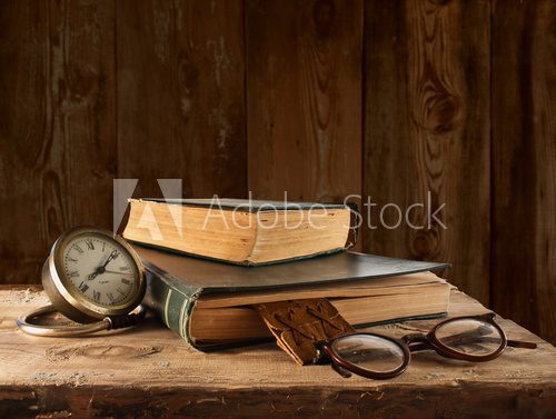 Vintage book, glasses and watches on the background of a wooden  Fototapety Sepia Fototapeta
