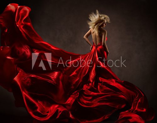 Woman in red waving dress with fluttering flying fabric  Plakaty do Sypialni Plakat