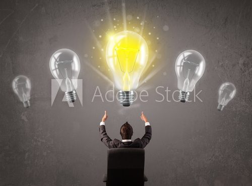 Business person having an idea light bulb concept  Plakaty do Biura Plakat
