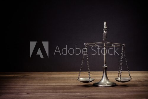 Law scales on table in front black background. Symbol of justice  Plakaty do Biura Plakat