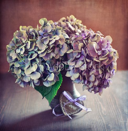 purple hydrangea flowers and a wooden heart on a table.  Obrazy do Sypialni Obraz