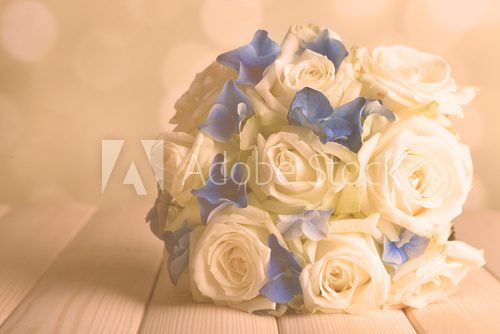 Beautiful wedding bouquet with roses on wooden table  Kwiaty Plakat