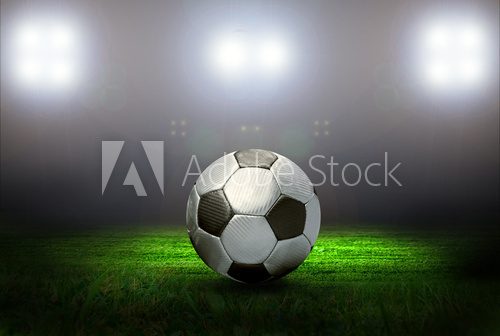 Soccer ball on the field of stadium with light  Stadion Fototapeta