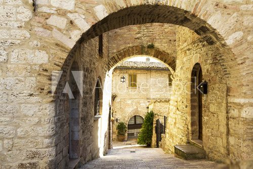 Street with arches in an old town from Tuscany  Fototapety Uliczki Fototapeta