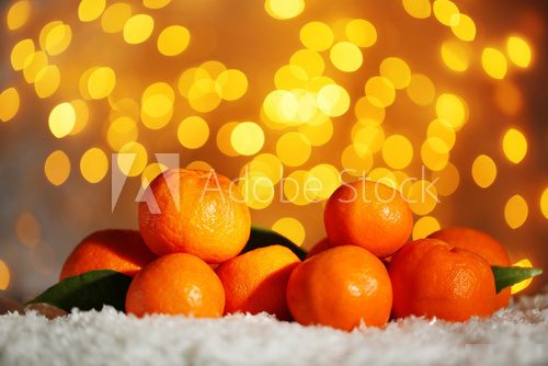 Fresh ripe mandarins on snow, on lights background  Owoce Obraz