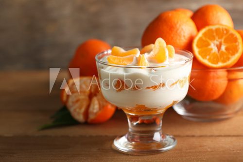 Tasty milk dessert with fresh tangerine pieces in glass bowl,  Obrazy do Jadalni Obraz