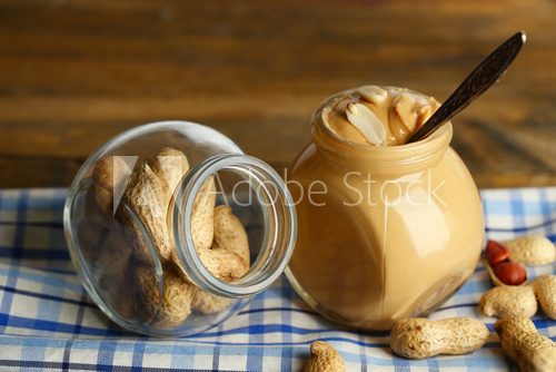 Fresh peanut butter in jar on wooden background  Obrazy do Kuchni  Obraz
