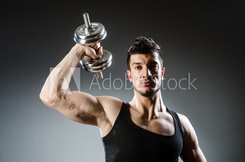 Muscular ripped bodybuilder with dumbbells  Fototapety do Klubu Fitness Fototapeta