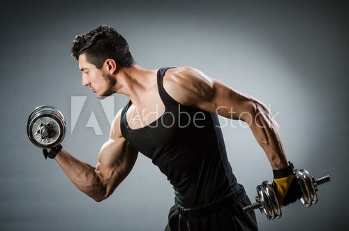 Muscular ripped bodybuilder with dumbbells  Fototapety do Klubu Fitness Fototapeta