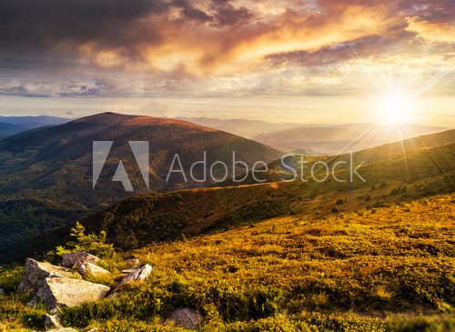 hillside with stones in high mountains at sunset  Fototapety Góry Fototapeta