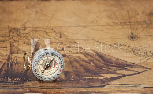 Vintage compass lies on an ancient map Styl Marynistyczny Fototapeta