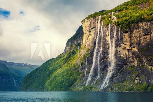 Geiranger fjord. Seven Sisters Waterfall, Norway. Mountain landscape with cloudy sky. Beautiful nature.  Fototapety Wodospad Fototapeta