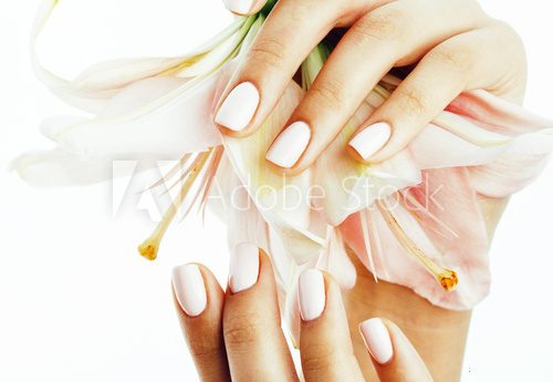 beauty delicate hands with manicure holding flower lily close up isolated on white Obrazy do Salonu Kosmetycznego Obraz