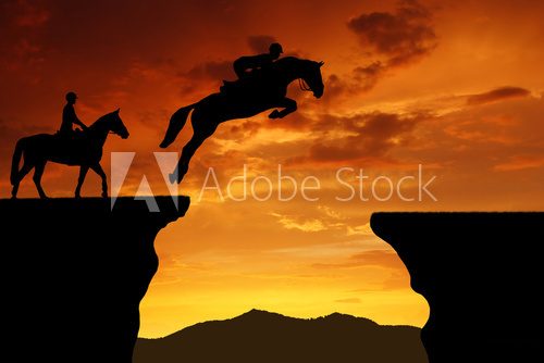 silhouette of a rider on a jumping horse  Zachód Słońca Fototapeta