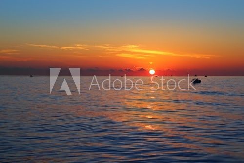 seascape sunrise first sun orange in blue sea  Zachód Słońca Fototapeta