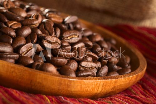 Roasted coffee beans on wooden plate on red cloth  Kawa Fototapeta