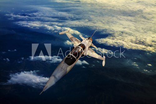 military jet plane flying over mountain country view below  Pojazdy Fototapeta