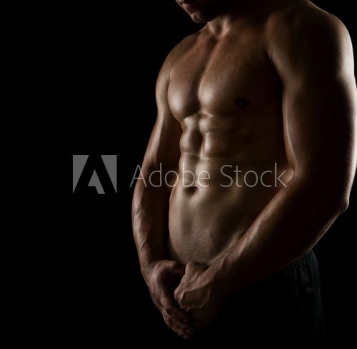 Close up of perfect male body isolated on black  Fototapety do Siłowni Fototapeta