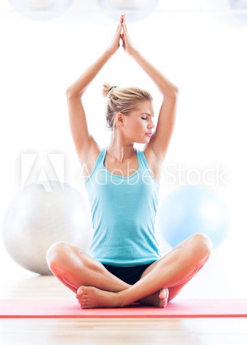 Woman sitting in lotus position  Fototapety do Klubu Fitness Fototapeta