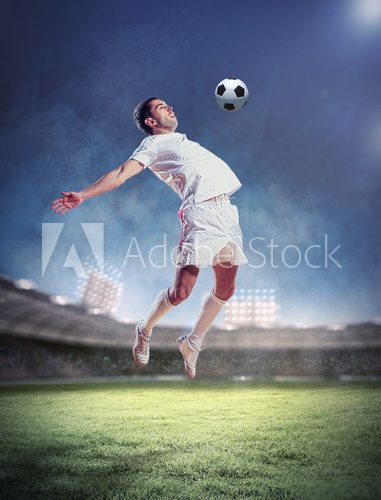 football player striking the ball  Stadion Fototapeta