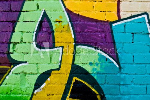 Graffity: Colorful detail on a textured brick wall Fototapety Graffiti Fototapeta