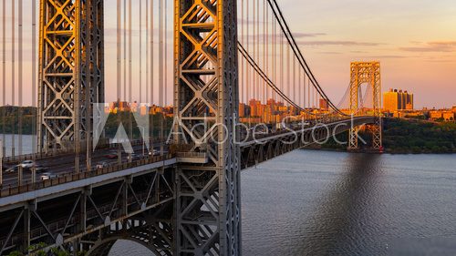 The George Washington Bridge (long-span suspension bridge) across the Hudson River at sunset. Uptown and Fort Washington Park, New York City, USA Mosty Obraz