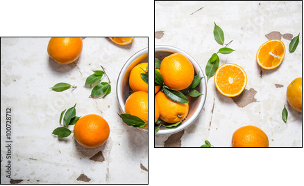 Orange style. Fresh oranges with leaves in a Cup . - Obraz dwuczęściowy, Dyptyk