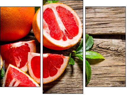 Fresh cut grapefruit with leaves. On wooden table. - Obraz trzyczęściowy, Tryptyk
