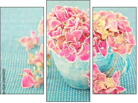 Pink hydrangea flowers in a cup on a blue background .  - Obraz trzyczęściowy, Tryptyk